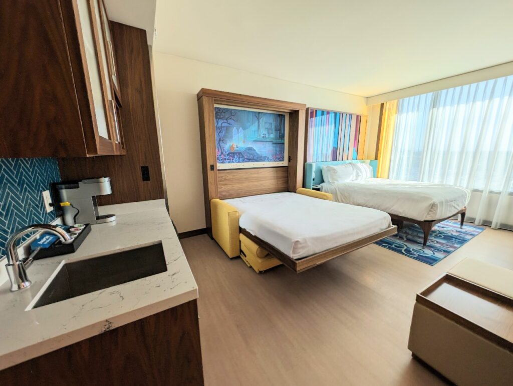 View of the Disneyland Hotel deluxe studio villa room when the Murphy bed is pulled down next to the regular bed.