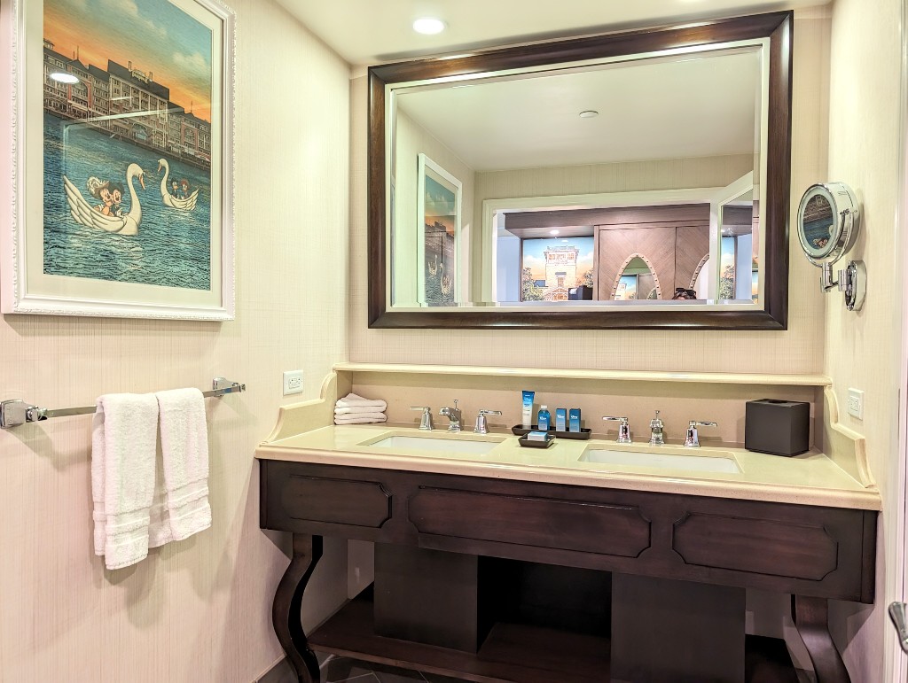 Dual sinks under a large mirror face directly into the Boardwalk Inn room entrance area