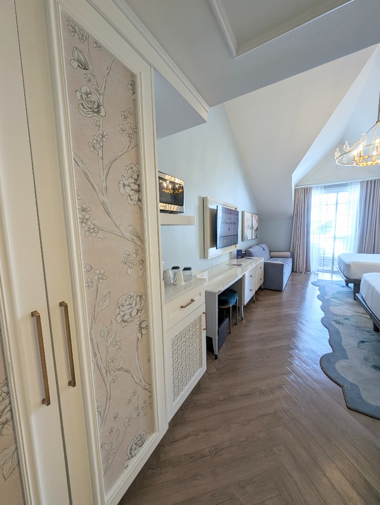 A view of the wallpaper inset closet doors, entrance, and general set up of the Grand Floridian Resort Studio Villa