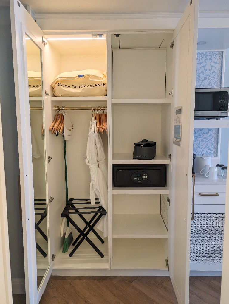 A closet with full hanging section on one side and shelving on the other provides most of the storage space in Grand Floridian Resort Studio Villas