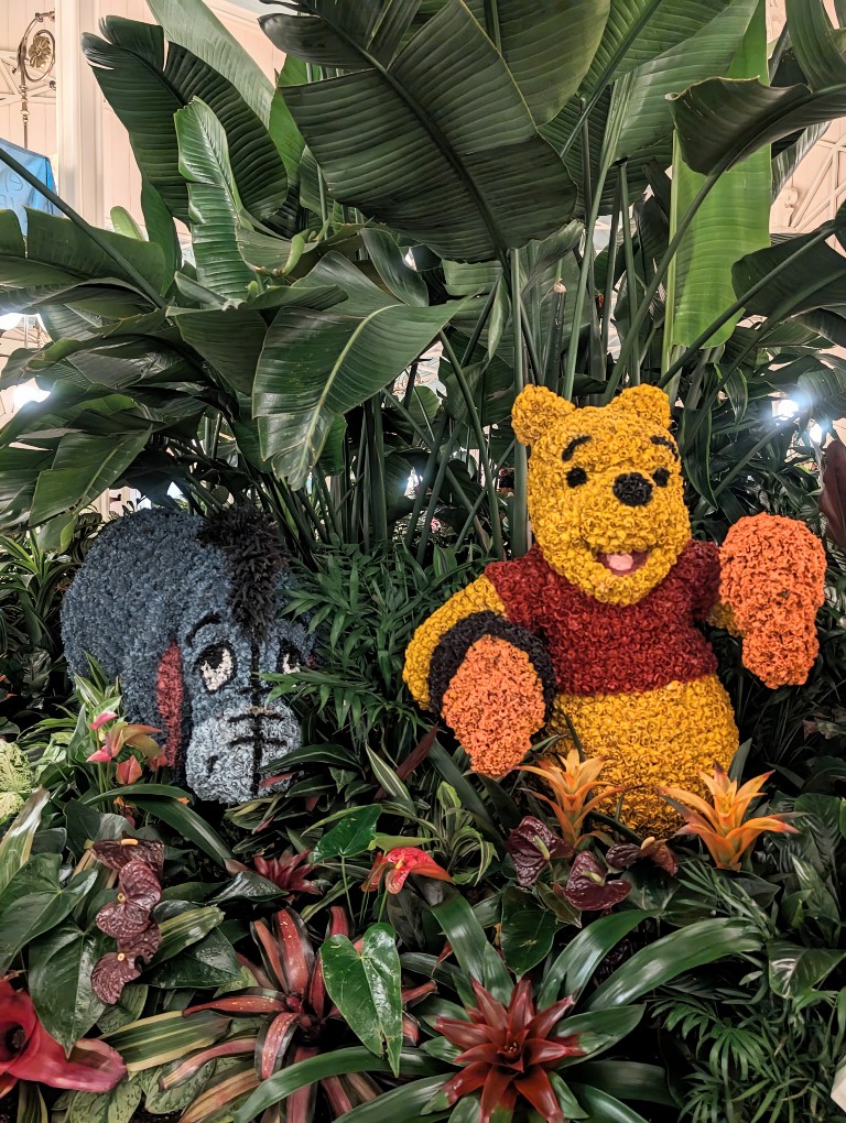 Winnie the Pooh and Eeyore topiaries are almost hidden in greenert at The Crystal Palace